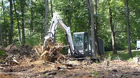 pulling bushes out with mini excavator|how to pull trees with excavators.